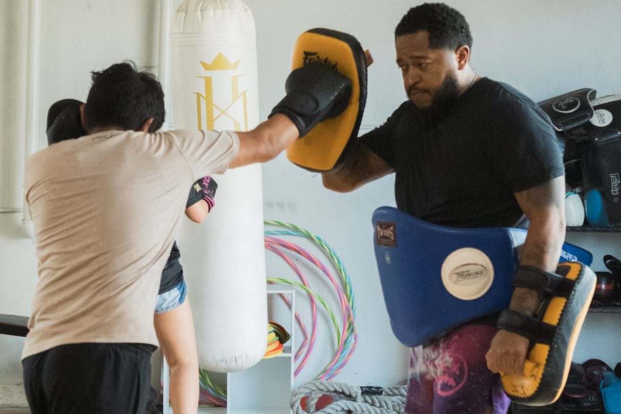Teen practicing Muay Thai with a coach at Kingdom Martial Arts Academy in San Antonio