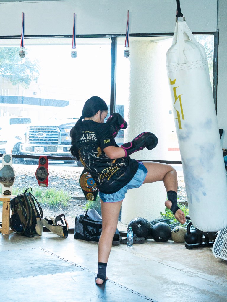 Teen practicing a Muay Thai knee strike at Kingdom Martial Arts Academy in San Antonio